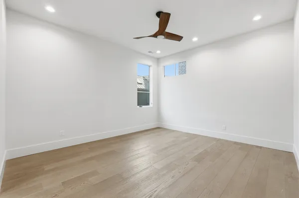 a view of empty room with wooden floor