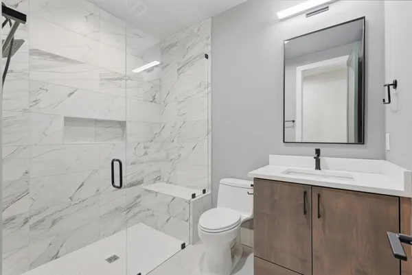 a bathroom with a sink toilet and shower