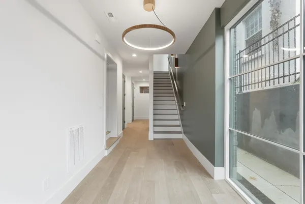 a view of entryway and hall with wooden floor
