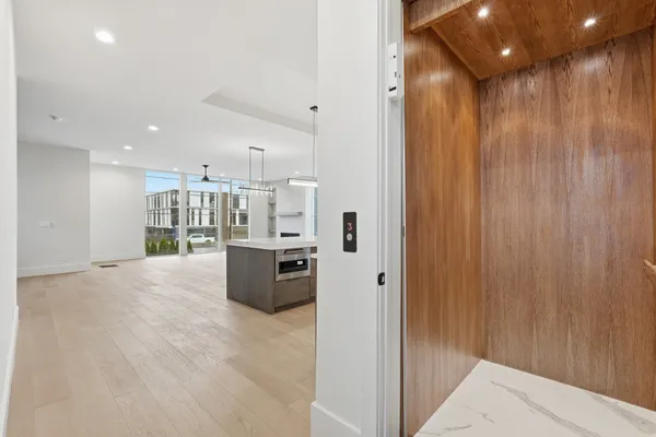 a view of kitchen with stainless steel appliances kitchen island refrigerator stove and kitchen island