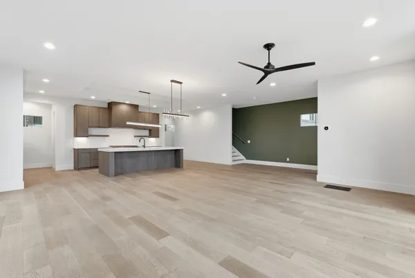 a view of kitchen with kitchen island a sink stainless steel appliances and cabinets