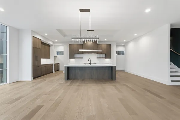 a large kitchen with kitchen island a sink stainless steel appliances and cabinets