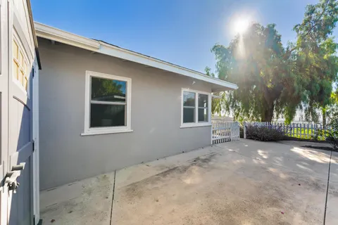a view of a house with a backyard and windows