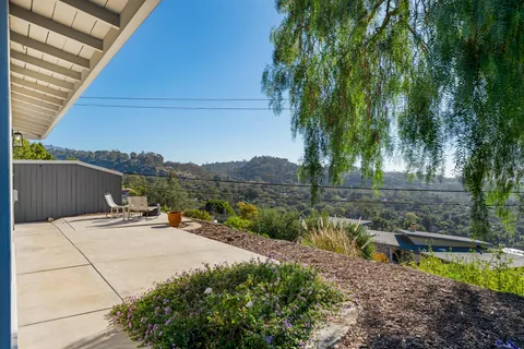 a view of a house with a yard and sitting area
