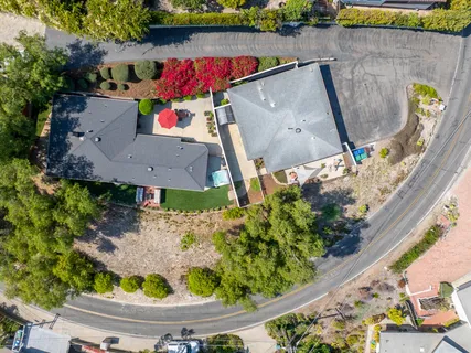 an aerial view of a house with a yard and a garden