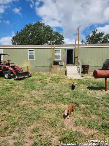 a view of a house with backyard sitting area and garden