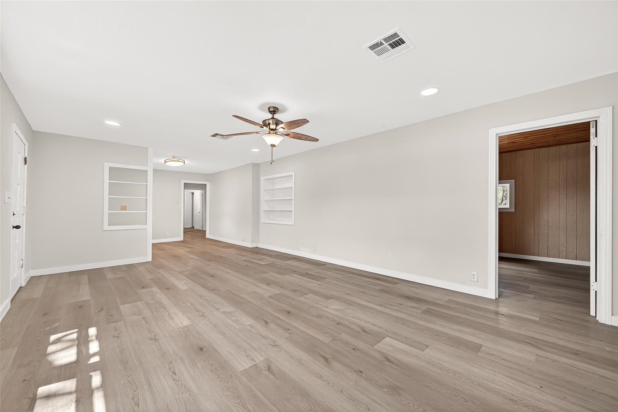 815 Brooks Avenue Rosenberg, TX 77471 - Photo 11 of 48 wooden floor in an empty room with a window