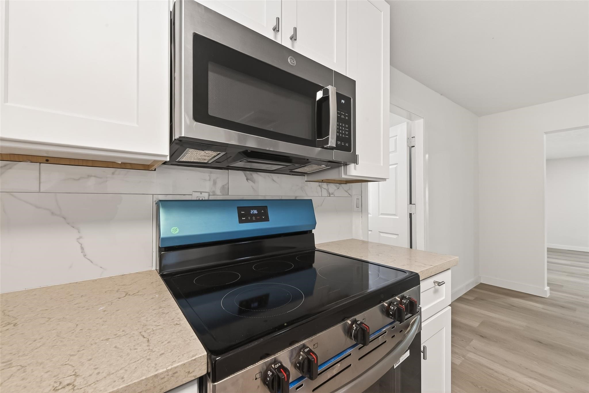 815 Brooks Avenue Rosenberg, TX 77471 - Photo 22 of 48 a kitchen with a stove and a microwave