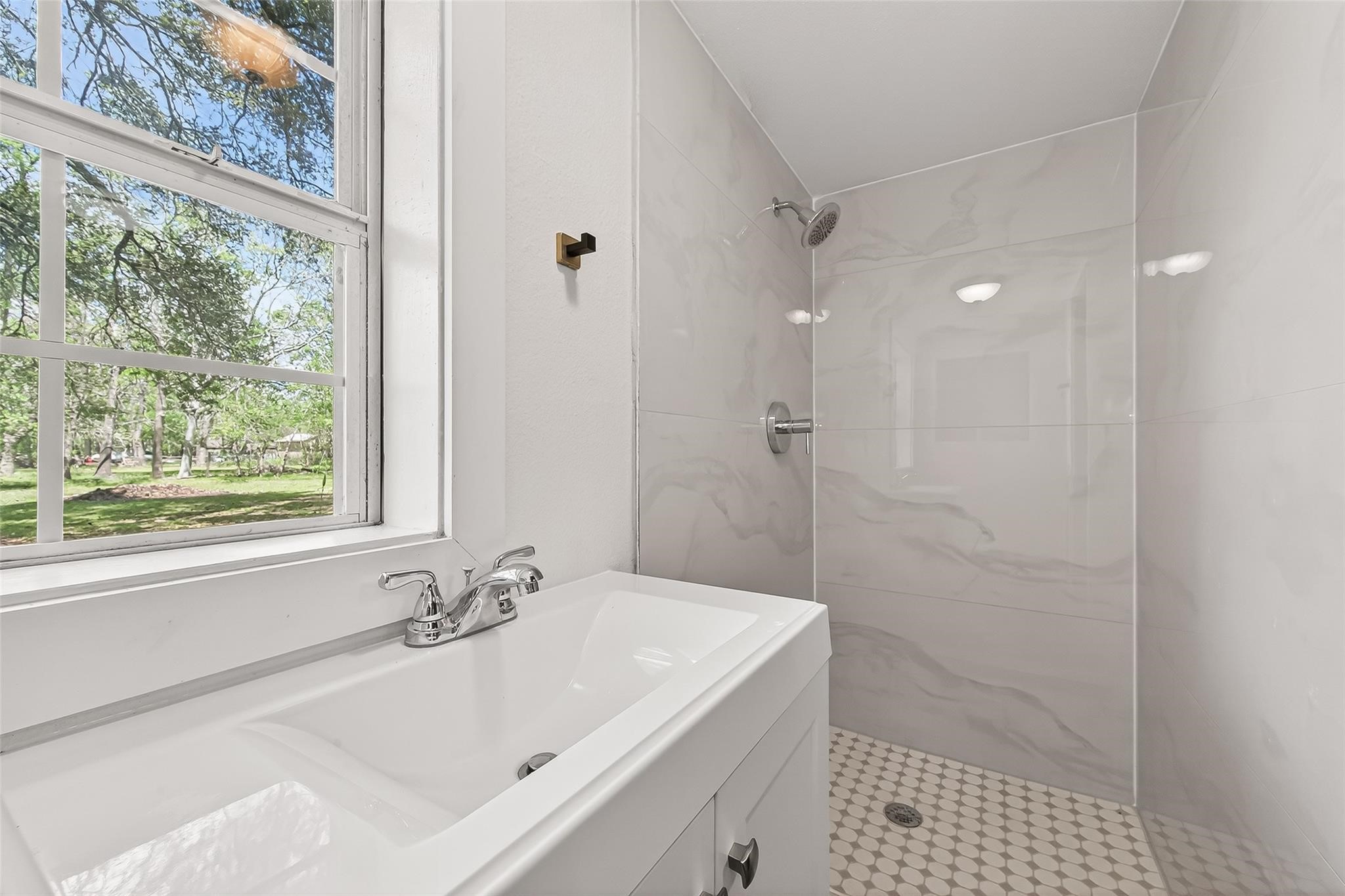 815 Brooks Avenue Rosenberg, TX 77471 - Photo 29 of 48 a bathroom with a sink a mirror and a shower