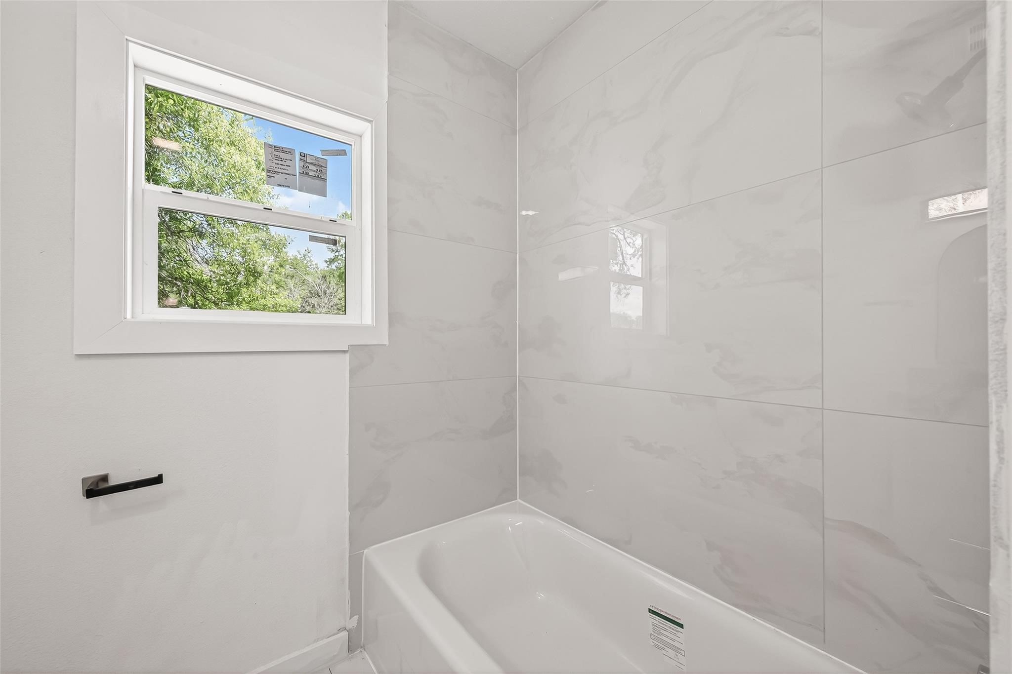 815 Brooks Avenue Rosenberg, TX 77471 - Photo 41 of 48 a bathroom with a bathtub and window