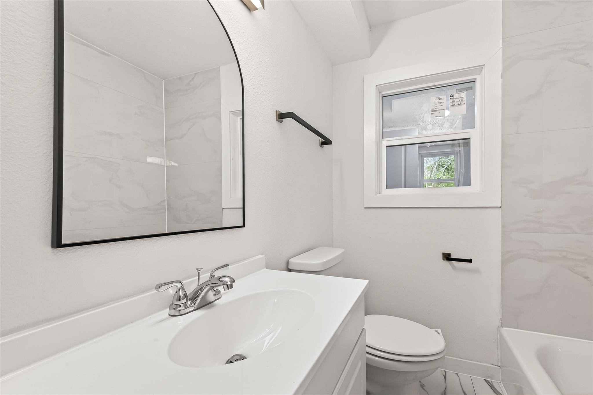 815 Brooks Avenue Rosenberg, TX 77471 - Photo 42 of 48 a bathroom with a toilet a sink a mirror and a window