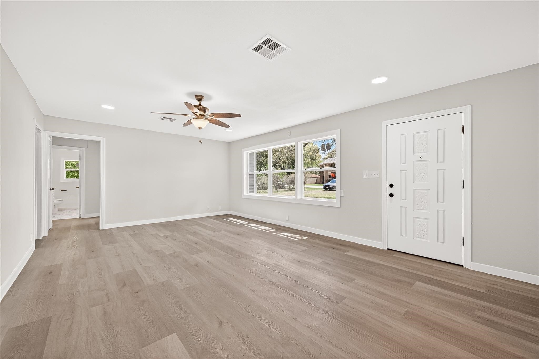 815 Brooks Avenue Rosenberg, TX 77471 - Photo 7 of 48 wooden floor in an empty room with a window