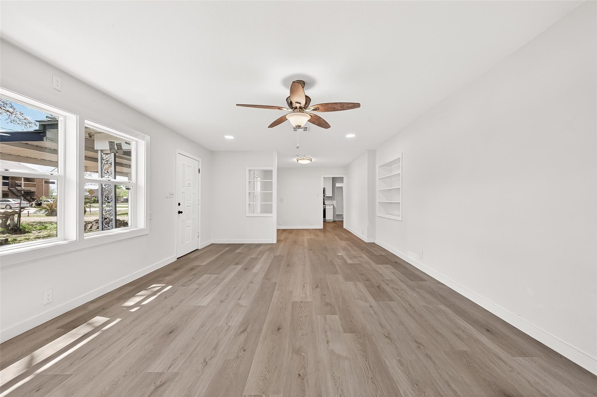 815 Brooks Avenue Rosenberg, TX 77471 - Photo 10 of 48 wooden floor in an empty room with a window