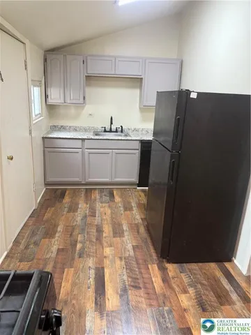 a kitchen with a refrigerator and a sink