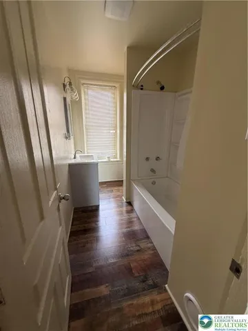 a bathroom with a bathtub and a shower