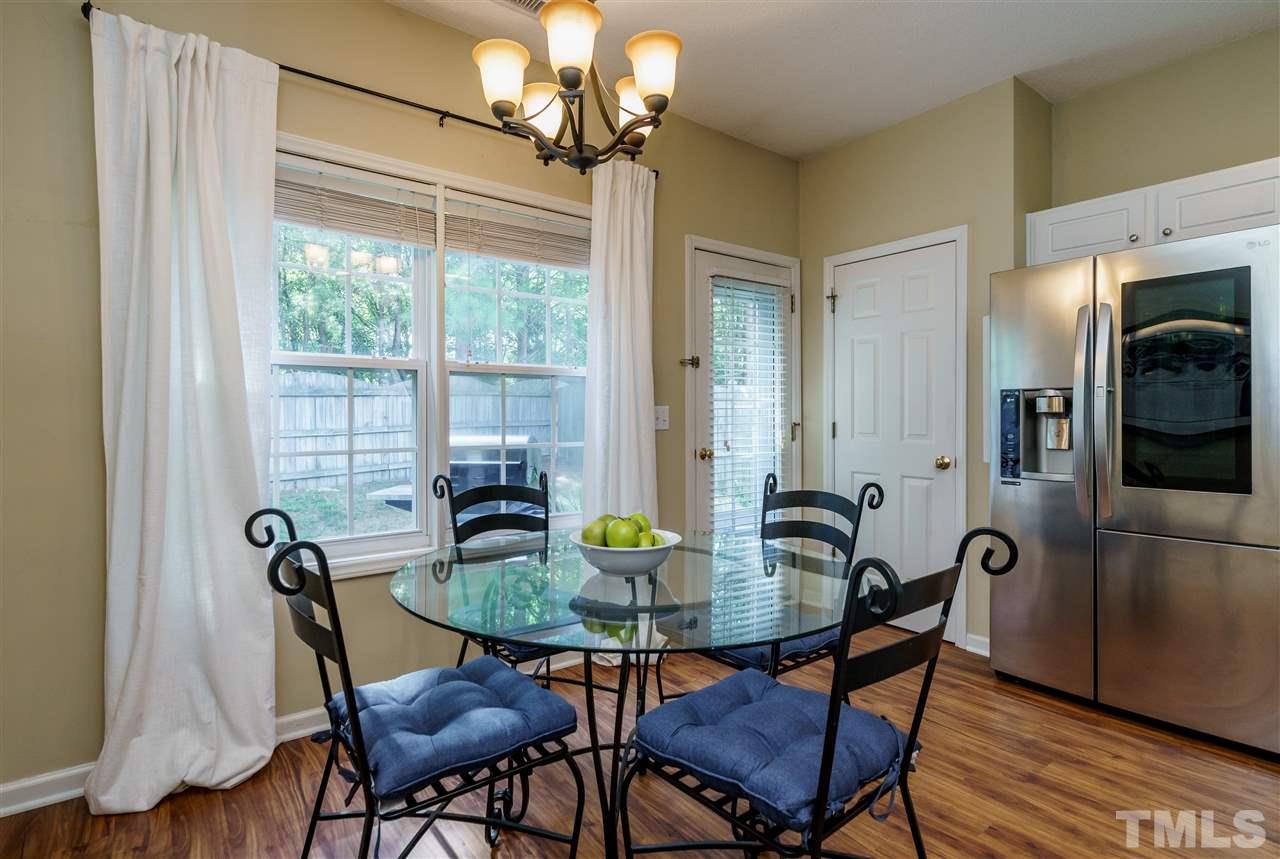 4848 Tommans Trail Raleigh, NC 27616 - Photo 13 of 22 a view of a dining room with furniture window and wooden floor