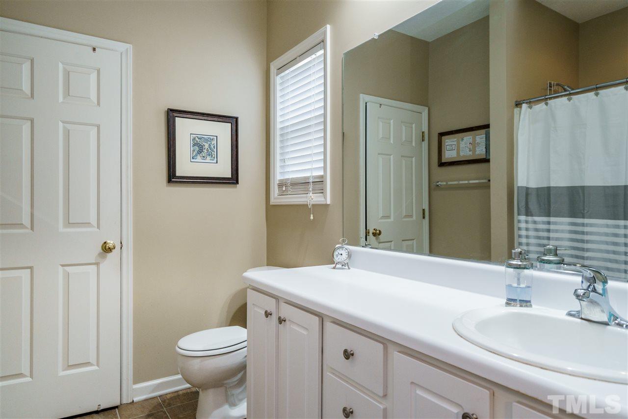 4848 Tommans Trail Raleigh, NC 27616 - Photo 15 of 22 a bathroom with a double vanity sink toilet and a mirror
