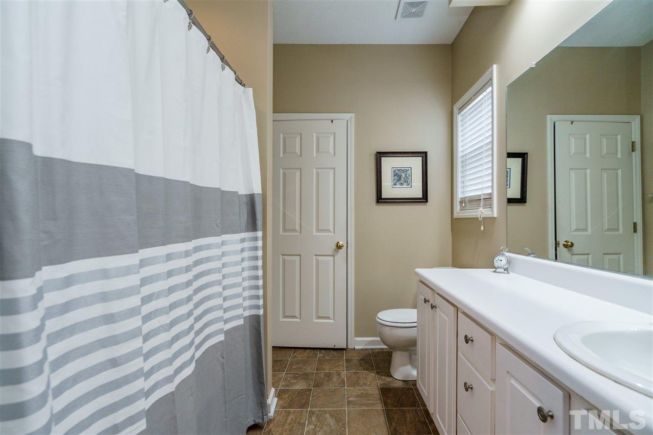 4848 Tommans Trail Raleigh, NC 27616 - Photo 16 of 22 a bathroom with a sink a toilet and shower