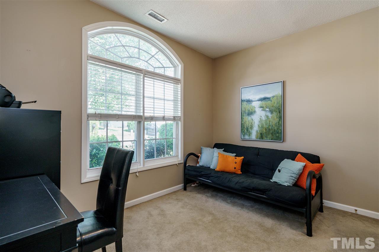 4848 Tommans Trail Raleigh, NC 27616 - Photo 17 of 22 a living room with furniture and a flat screen tv