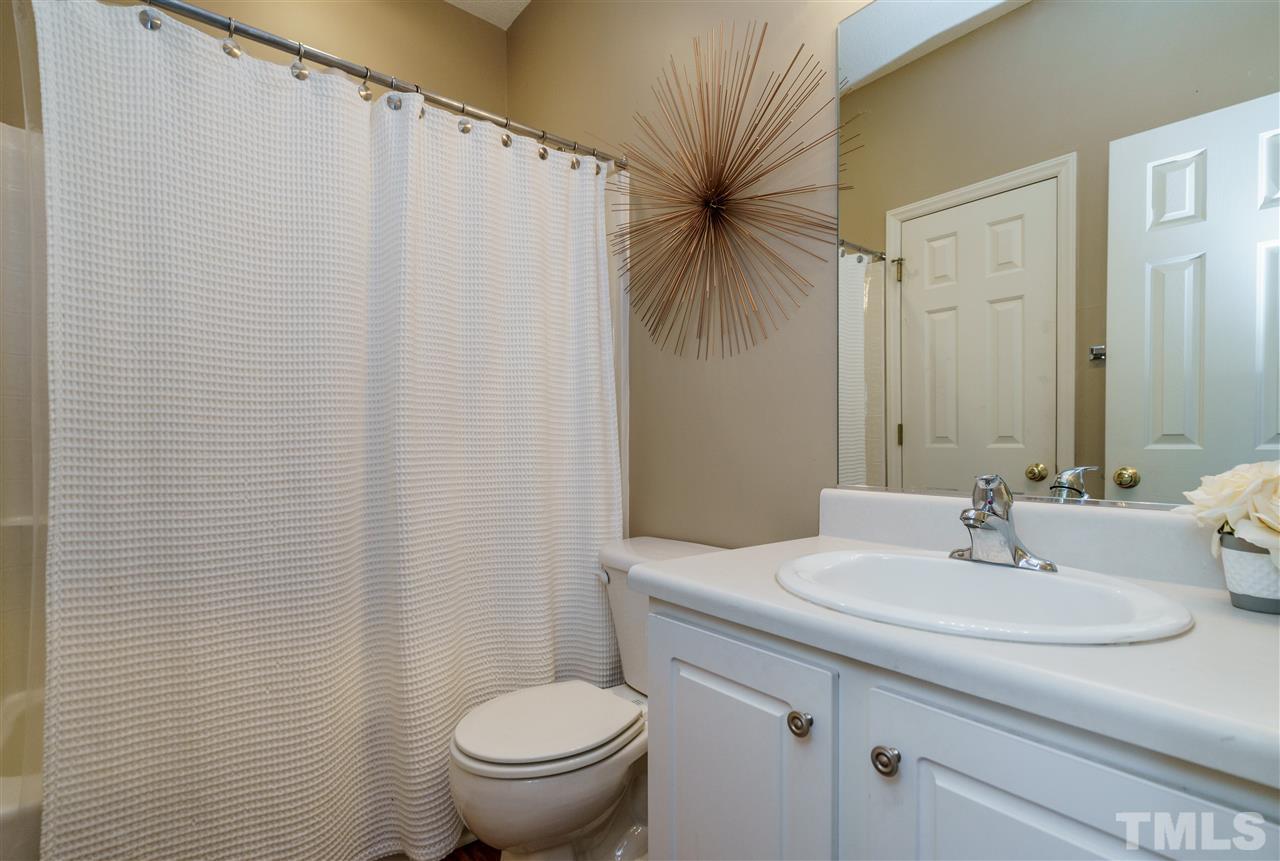 4848 Tommans Trail Raleigh, NC 27616 - Photo 18 of 22 a bathroom with a sink a toilet and a mirror