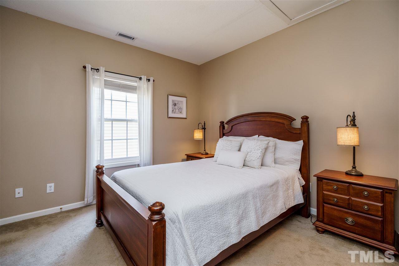 4848 Tommans Trail Raleigh, NC 27616 - Photo 19 of 22 a bedroom with a bed and a window