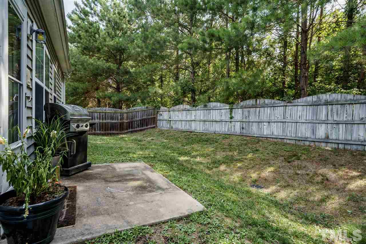 4848 Tommans Trail Raleigh, NC 27616 - Photo 21 of 22 a view of a backyard with a garden