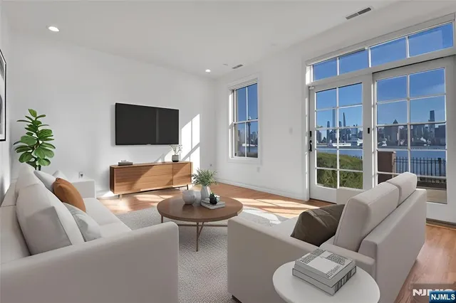 a living room with furniture a lamp and a flat screen tv