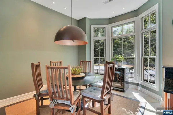 a dining room with furniture and a floor to ceiling window
