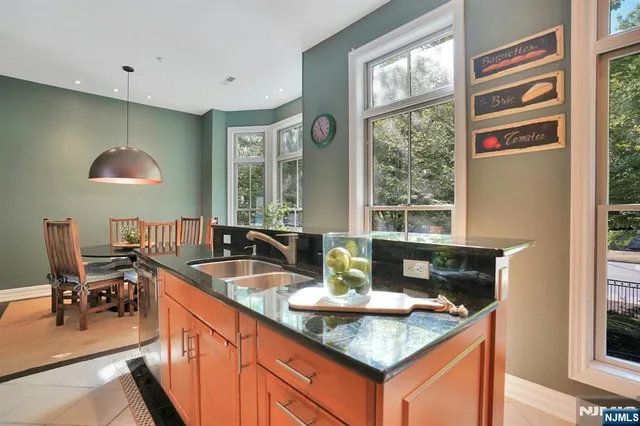 a kitchen with granite countertop a sink and a window