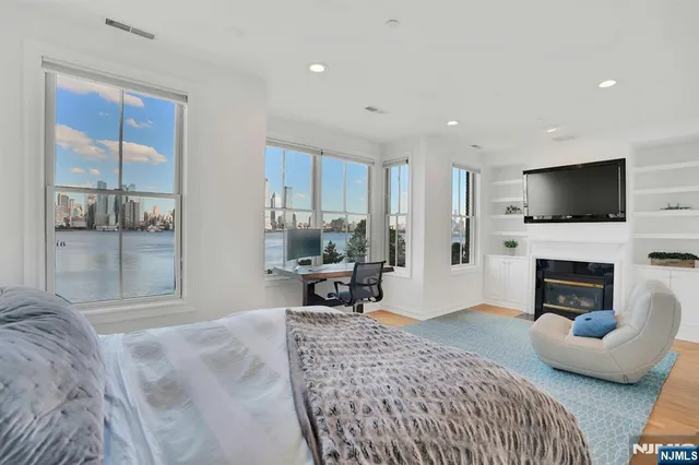 a living room with furniture a fireplace and a flat screen tv