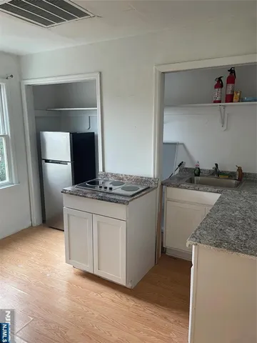 a kitchen with granite countertop a sink and a stove