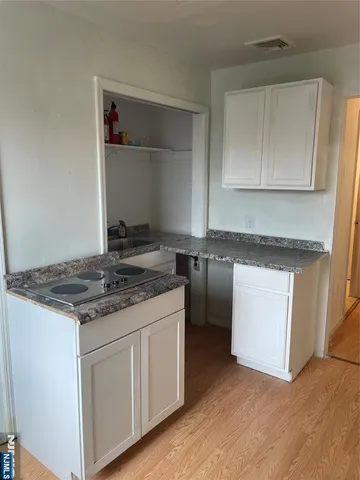 a kitchen with granite countertop a stove and a sink