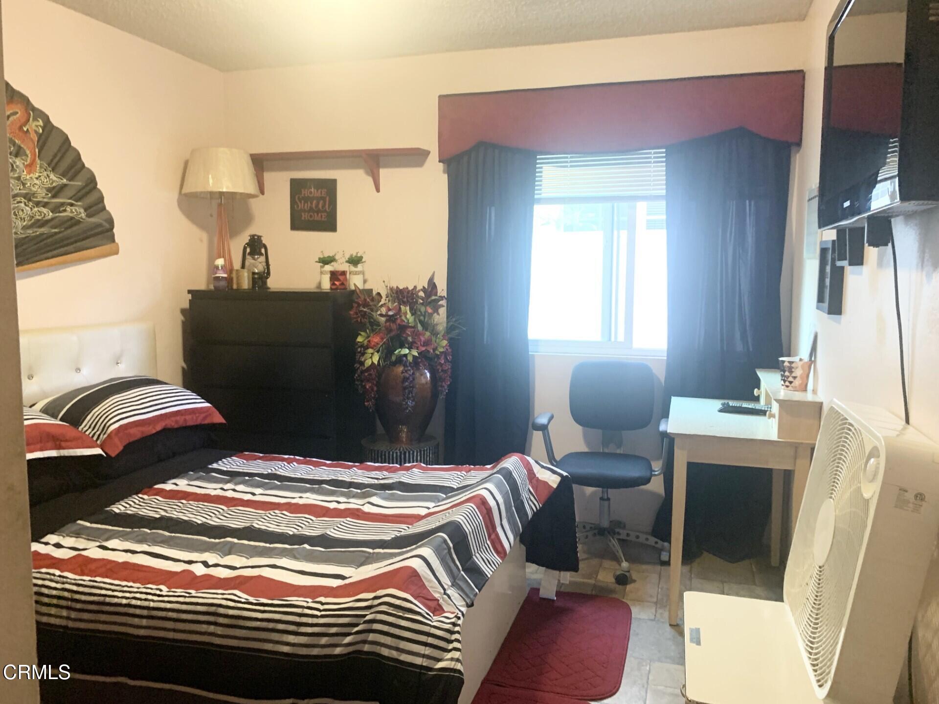 931 Devilfish Drive Oxnard, CA 93035 - Photo 4 of 7 a bedroom with a bed and a mirror on the dresser