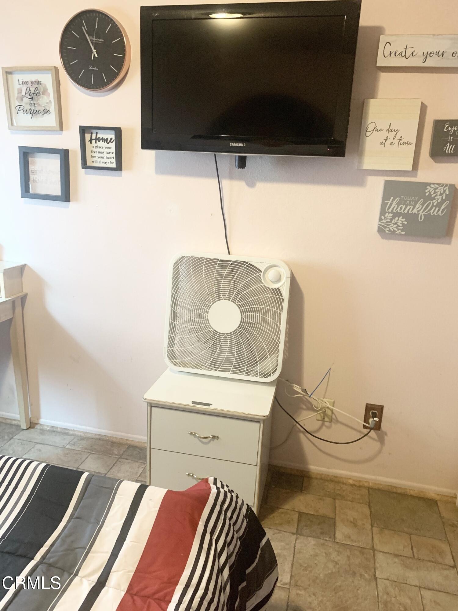 931 Devilfish Drive Oxnard, CA 93035 - Photo 6 of 7 a living room with a couch and a flat screen tv