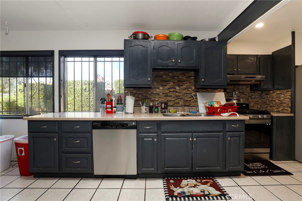 12623 Slater Avenue Compton, CA 90222 - Photo 11 of 35 a kitchen with stainless steel appliances a sink and a counter