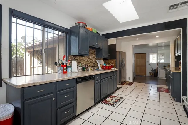 a kitchen with granite countertop a sink and cabinets