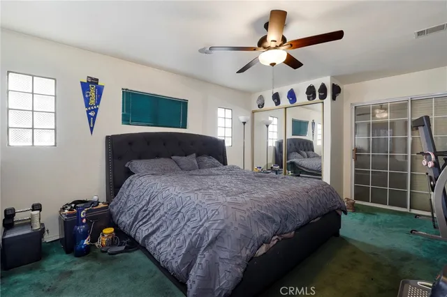 a bedroom with bed and window