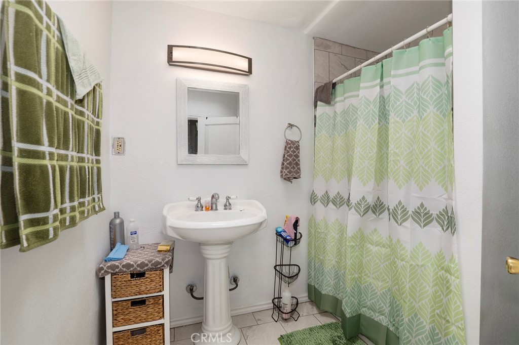 12623 Slater Avenue Compton, CA 90222 - Photo 25 of 35 a bathroom with a sink mirror and shower