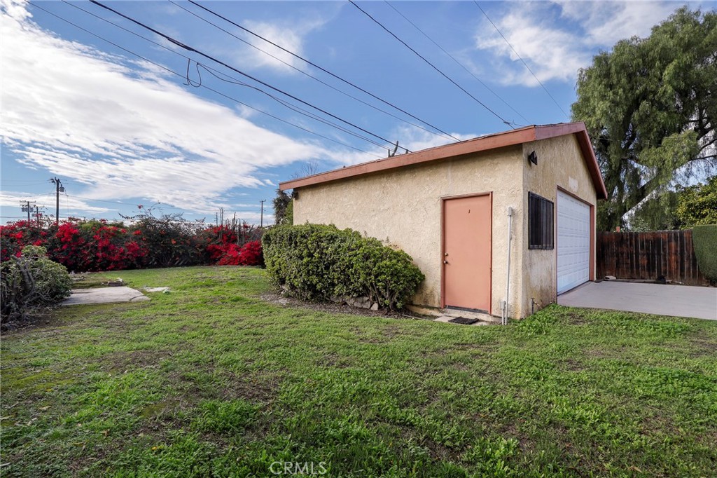12623 Slater Avenue Compton, CA 90222 - Photo 31 of 35 a view of a backyard with potted plants and large tree