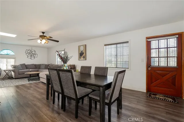 a view of a a dining room with furniture window and wooden floor