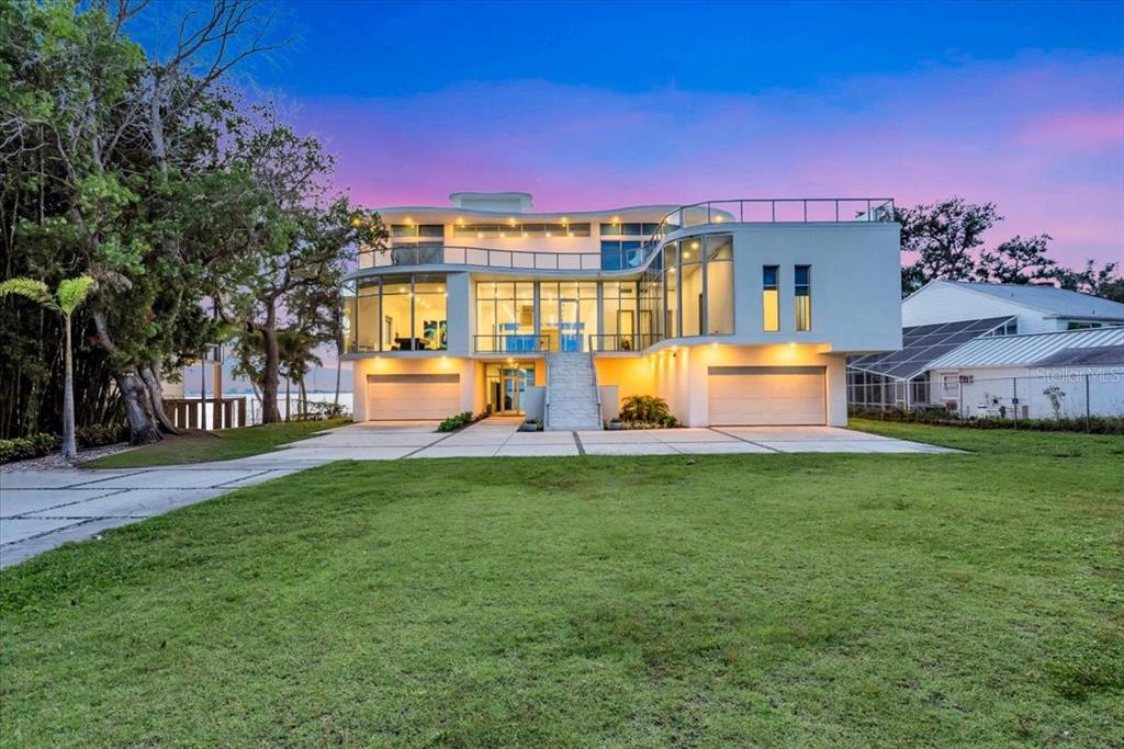 a front view of a house with swing and wooden fence