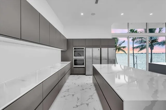 a large white kitchen with a large window