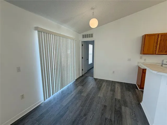 a view of a room with wooden floor and bathroom
