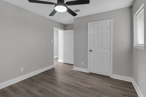 a view of an empty room and wooden floor