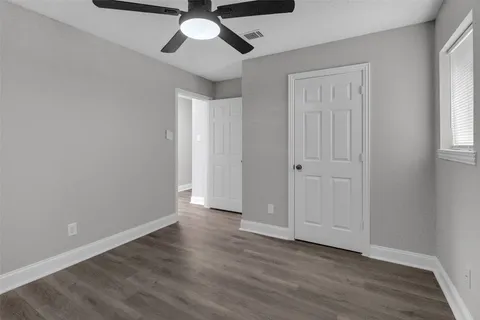 a view of an empty room and wooden floor