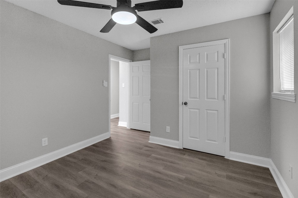 3613 Crane Street Houston, TX 77026 - Photo 11 of 23 an empty room with wooden floor chandelier fan and windows