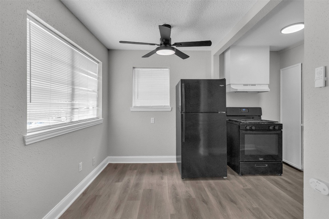 3613 Crane Street Houston, TX 77026 - Photo 15 of 23 a kitchen with granite countertop a refrigerator and a stove top oven