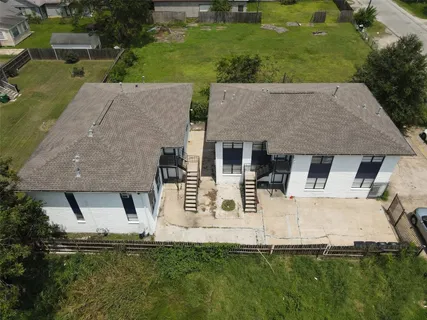 an aerial view of a house with a yard and lake view