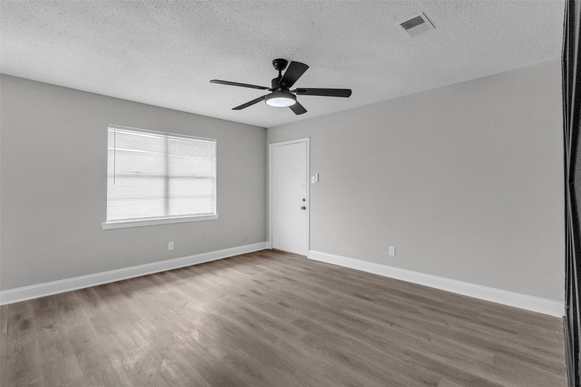 3613 Crane Street Houston, TX 77026 - Photo 5 of 23 wooden floor in an empty room with a window