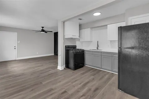 a kitchen with a stove sink and refrigerator